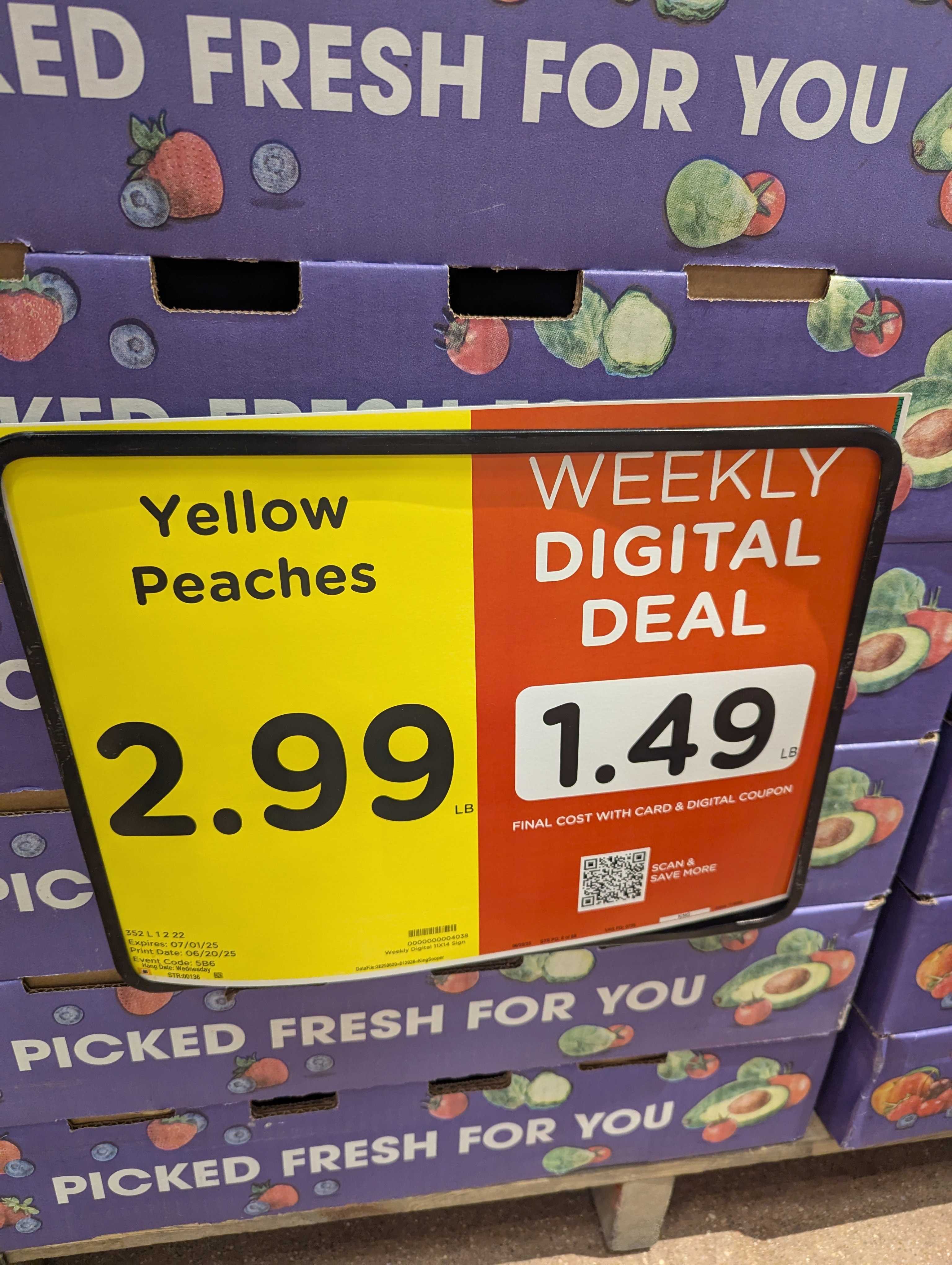 King Soopers store pricing display showing regular price of $2.99 and digital coupon price of $1.49 for yellow peaches